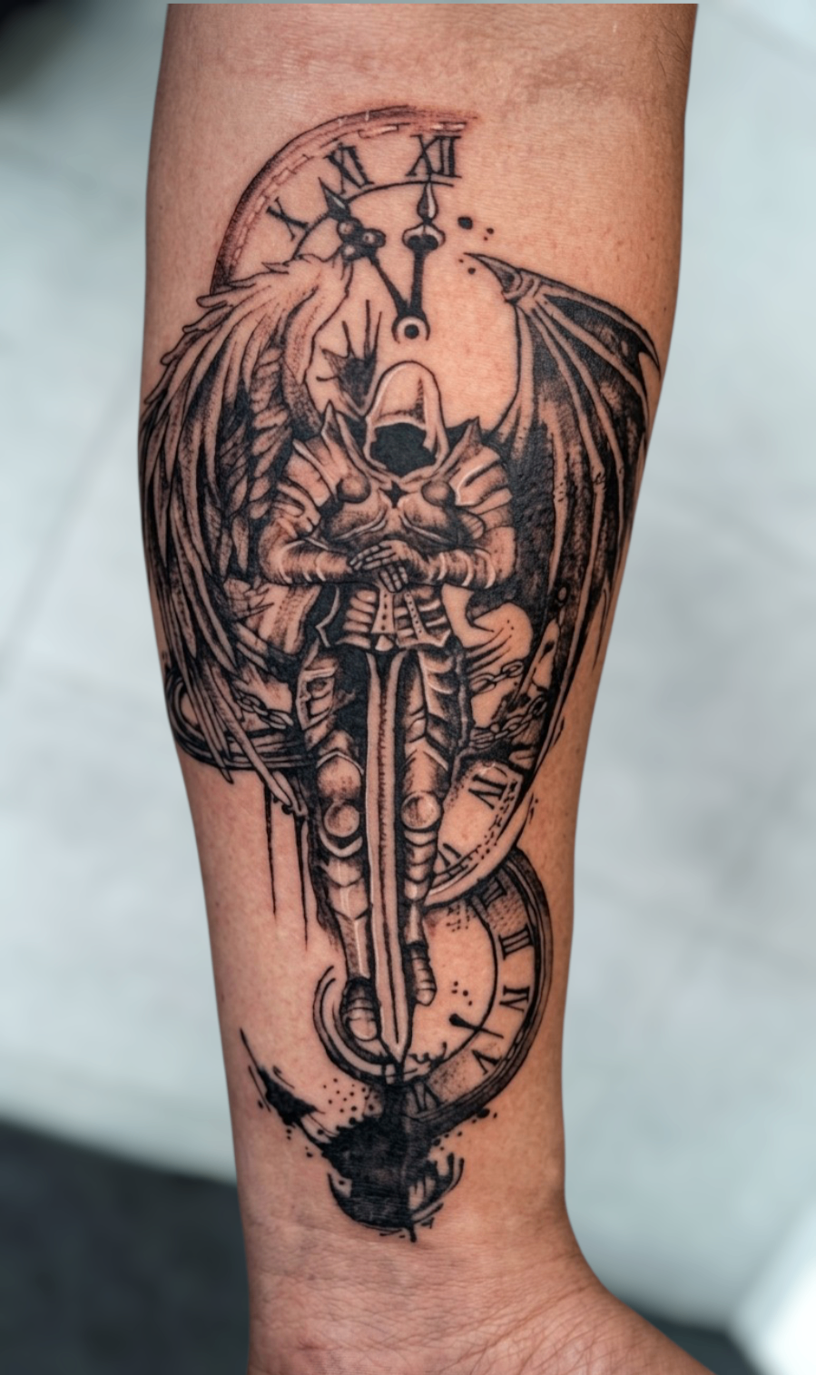 Tatuaje blackwork de ángel con espada y reloj romano